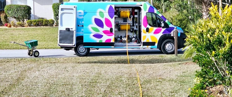Work van and yellow hose on a property in New Smyrna Beach, FL.