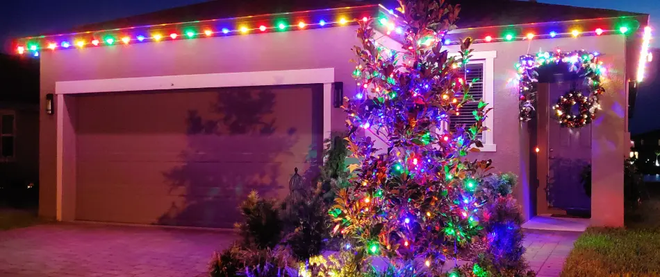 Colorful Christmas lights on a home and tree in New Smyrna Beach, FL.