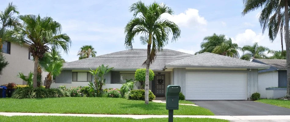 Attractive home with lush landscaping and palm trees in New Smyrna Beach, FL.